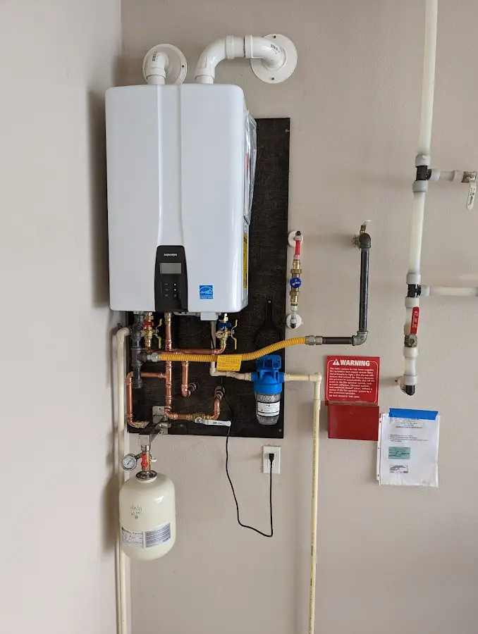 Professional plumber installing copper piping in a Irvington home